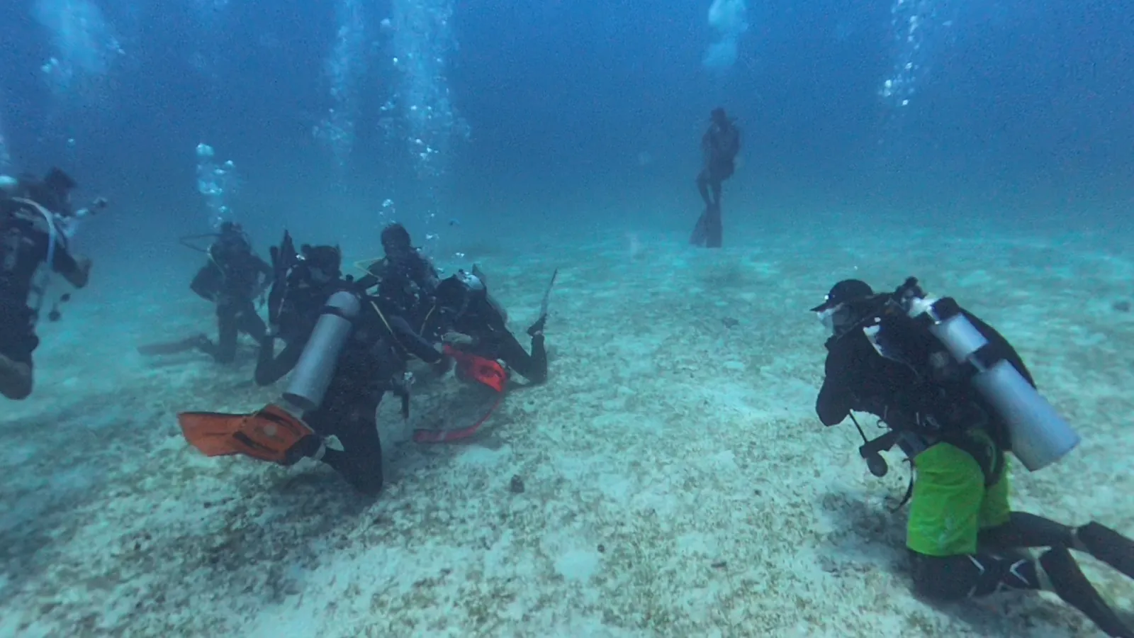 Illustrative group of divers practising underwater skills in a Hong Kong training context